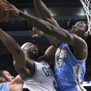 Boston Celtics power forward Chris Wilcox, center, goes to the hoop against Denver Nuggets small forward Kenneth Faried, right, during the first half of an NBA basketball game in Boston, Sunday, Feb. 10, 2013. (AP Photo/Elise Amendola)