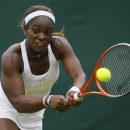 Sloane Stephens of the United States returns to Monica Puig of Puerto Rico during their Women's singles match at the All England Lawn Tennis Championships in Wimbledon, London, Monday, July 1, 2013. (AP Photo/Kirsty Wigglesworth)