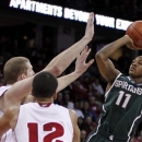 Michigan State's Keith Appling shoots against Wisconsin's Evan Anderson, left, and Traevon Jackson (12) during the first half of an NCAA college basketball game Tuesday, Jan. 22, 2013, in Madison, Wis. Appling had a game-high 19 points in Michigan State's 49-47 win. (AP Photo/Andy Manis)