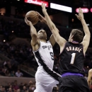 San Antonio Spurs' Tony Parker (9), of France, shoots over Phoenix Suns' Goran Dragic (1), of Slovenia, during the first half of an NBA basketball game, Wednesday, Feb. 27, 2013, in San Antonio. (AP Photo/Eric Gay)