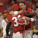 Georgia quarterback Aaron Murray (11) embraces wide receiver Chris Conley (31) as they celebrate after their 44-41 win over LSU in an NCAA football game against the LSU, Saturday, Sept. 28, 2013, in Athens, Ga. (AP Photo/Mike Stewart)