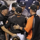 Baltimore Orioles manager Buck Showalter, center, argues with New York Yankees manager Joe Girardi, center left, at the end of the first inning of a baseball game, Monday, Sept. 9 2013, in Baltimore. (AP Photo/Luis M. Alvarez)