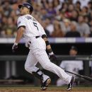 Colorado Rockies' Carlos Gonzalez hits a double against the Houston Astros in the fourth inning of a baseball game on Thursday, May 31, 2012, in Denver. (AP Photo/Joe Mahoney)