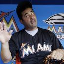 Miami Marlins manager Ozzie Guillen talks with reporters in the dugout before a baseball game against the Cincinnati Reds, Saturday, Sept. 15, 2012, in Miami. (AP Photo/Lynne Sladky)