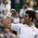 Novak Djokovic of Serbia reacts after defeating Tommy Haas of Germany during a Men's singles match at the All England Lawn Tennis Championships in Wimbledon, London, Monday, July 1, 2013. (AP Photo/Alastair Grant)