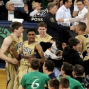 Notre Dame players including Cameron Biedscheid (1) celebrate with fans following their 104-101 win against Louisville in the fifth overtime of their NCAA college basketball game, Saturday, Feb. 9, 2013, in South Bend, Ind. (AP Photo/Joe Raymond)