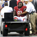 Arizona Cardinals first round draft pick Jonathan Cooper (61) is carted off the field after being injured during the second half of a preseason NFL football game against the San Diego Chargers, Saturday, Aug. 24, 2013, in Glendale, Ariz. (AP Photo/Rick Scuteri)