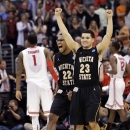 Wichita State's Carl Hall (22) and Fred Van Vleet celebrate their team's 70-66 win over Ohio State in the West Regional final in the NCAA men's college basketball tournament, Saturday, March 30, 2013, in Los Angeles. Ohio State's Deshaun Thomas (1) walks off at left. (AP Photo/Jae C. Hong)