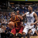 ORLANDO, FL - FEBRUARY 23: Kyrie Irving #2 of the Cleveland Cavaliers drives against E'Twaun Moore #55 of the Orlando Magic during the game between the Cleveland Cavaliers and the Orlando Magic on February 23, 2013 at Amway Center in Orlando, Florida. (Photo by Fernando Medina/NBAE via Getty Images)