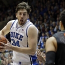 Duke's Ryan Kelly (34) drives to the basket as Miami's Shane Larkin (0) defends during the first half of an NCAA college basketball game in Durham, N.C., Saturday, March 2, 2013. Duke won 79-76. (AP Photo/Gerry Broome)