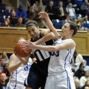 Monmouth's Chevannah Paalvast (10) wrestles a rebound away from Duke 's Haley Peters (33) during the first half of an NCAA women's college basketball game in Durham, N.C., Sunday, Dec. 30, 2012. Duke's Tricia Liston (32) watches the play. (AP Photo/Bob Leverone)