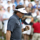 Phil Mickelson reacts after sinking a birdie putt on the 11th green during the first round of the Deutsche Bank Championship golf tournament in Norton, Mass., Friday, Aug. 30, 2013. (AP Photo/Stew Milne)