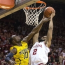 Indiana's Christian Watford (2) drives to the basket and is fouled by Michigan's Tim Hardaway Jr. (10) during the second half of an NCAA college basketball game Saturday, Feb. 2, 2013, in Bloomington, Ind. Indiana defeated Michigan 81-73. (AP Photo/Doug McSchooler)