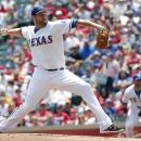 Texas Rangers pitcher Colby Lewis throws against the Colorado Rockies during the first inning of an interleague baseball game on Saturday, June 23, 2012, in Arlington, Texas. (AP Photo/Tim Sharp)