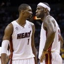 Miami Heat center Chris Bosh (1) speaks with forward LeBron James (6) during the first half of Game 5 in the NBA basketball playoffs Eastern Conference finals against the Indiana Pacers, Thursday, May 30, 2013, in Miami. (AP Photo/Lynne Sladky)