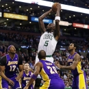 Boston Celtics forward Kevin Garnett (5) shoots while surrounded by Los Angeles Lakers during the first half of an NBA basketball game in Boston, Thursday, Feb. 7, 2013. (AP Photo/Charles Krupa)