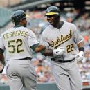 Oakland Athletics' Chris Carter (22) smiles with Yoenis Cespedes (52) after Carter hit a two-run home run against the Baltimore Orioles during the first inning of a baseball game, Friday, July 27, 2012, in Baltimore. (AP Photo/Nick Wass)