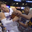 Los Angeles Clippers forward Blake Griffin, left, struggles for the ball with Utah Jazz forward Derrick Favors during the first half of an NBA basketball game, Sunday, Dec. 30, 2012, in Los Angeles. (AP Photo/Mark J. Terrill)