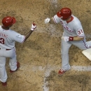 Philadelphia Phillies' Erik Kratz (31) is congratulated by Delmon Young (3) after Kratz hit a two-run home run during the fourth inning of a baseball game against the Milwaukee Brewers on Friday, June 7, 2013, in Milwaukee. (AP Photo/Morry Gash)