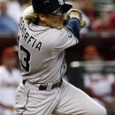 San Diego Padres' Chris Denorfia (13) hits an RBI double in the sixth inning against the Arizona Diamondbacks during a baseball game, Thursday, Sept. 20, 2012, in Phoenix. (AP Photo/Rick Scuteri)
