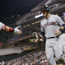 Cleveland Indians' Yan Gomes, right, is greeted by Nick Swisher as he scores on a single by Michael Brantley off Minnesota Twins pitcher Josh Roenicke in the eighth inning of a baseball game, Thursday, Sept. 26, 2013, in Minneapolis. The Indians won 6-5. Gomes hit a two-run home run in the fourth. (AP Photo/Jim Mone)