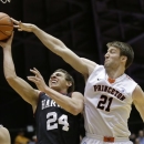 Harvard's Jonah Travis (24) takes a shot past Princeton's Mack Darrow (21) during the first half of an NCAA college basketball game Friday, March 1, 2013, in Princeton, N.J. (AP Photo/Mel Evans)
