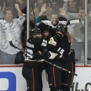 Anaheim Ducks' Bobby Ryan, center, celebrates his goal with Francois Beauchemin, left, and Ryan Getzlaf during the third period of an NHL hockey game against the Chicago Blackhawks in Anaheim, Calif., Wednesday, March 20, 2013. The Ducks won 4-2. (AP Photo/Jae C. Hong)