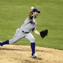 New York Mets' R.A. Dickey delivers a pitch during the third inning of a baseball game against the Miami Marlins, Friday, Aug. 31, 2012 in Miami. (AP Photo/Wilfredo Lee)