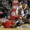 Atlanta Hawks guard Jeff Teague (0) comes up with a loose ball against Miami Heat guard Norris Cole (30) in the first half of an NBA basketball game, Wednesday, Feb. 20, 2013, in Atlanta. (AP Photo/John Bazemore)