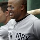 New York Yankees' Andruw Jones smiles in the dugout after hitting his second solo home run against the Boston Red Sox in the fourth inning of the first baseball game in a day-night doubleheader at Fenway Park in Boston Saturday, July 7, 2012. (AP Photo/Elise Amendola)