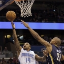 Orlando Magic point guard Jameer Nelson (14) shoots in front of Indiana Pacers' David West (21) during the first half of an NBA preseason basketball game on Friday,Oct. 19, 2012, in Orlando, Fla. (AP Photo/John Raoux)
