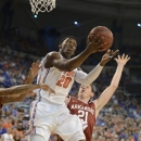 Florida guard Michael Frazier II (20) tries to get to the basket with Arkansas forward Hunter Mickelson (21) defending during the first half of an NCAA college basketball game in Gainesville, Fla., Saturday, Feb. 23, 2013. (AP Photo/Phil Sandlin)