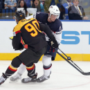 Germany defender Constantin Braun, left, battles for the puck with USA forward Brock Nelson during the Group B preliminary round match between USA and Germany at the Ice Hockey World Championship in Minsk, Belarus, Tuesday, May 20, 2014. (AP Photo/Darko Bandic)