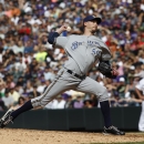 Milwaukee Brewers relief pitcher John Axford works against the Colorado Rockies in the eighth inning of the Rockies' 6-5 victory in a baseball game in Denver on Sunday, July 28, 2013. (AP Photo/David Zalubowski)