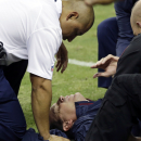 Houston Texans head coach Gary Kubiak, center, is helped after he collapsed on the field during the second quarter of an NFL football game against the Indianapolis Colts, Sunday, Nov. 3, 2013, in Houston. (AP Photo/David J. Phillip)
