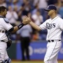 Tampa Bay Rays catcher Jose Molina, left, congratulates starting pitcher Alex Cobb after the Rays shut out the Oakland Athletics 5-0 during a baseball game Thursday, Aug. 23, 2012, in St. Petersburg, Fla. (AP Photo/Chris O'Meara)