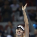 Maria Sharapova of Russia waves at spectators after winning against Ana Ivanovic of Serbia during the semi final match of the China Open tennis tournament at the National Tennis Stadium in Beijing, China, Saturday, Oct. 4, 2014. (AP Photo/Vincent Thian)
