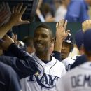Tampa Bay Rays' B.J. Upton, center, is congratulated in the dugout after hitting a two-run home run during the fifth inning of a baseball game against the Toronto Blue Jays in St. Petersburg, Fla., Saturday, Sept. 22, 2012.(AP Photo/Phelan M. Ebenhack)