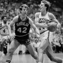 FILE - In this April 21, 1984, file photo, Seattle SuperSonics' Tom Chambers drives to the basket past Dallas Mavericks' Pat Cummings during an NBA basketball game in Seattle. Cummings, who played with five NBA teams over a 12-year career after being selected Metro Conference Player of the Year at Cincinnati, was found dead in a New York apartment on Tuesday, June 26, 2012, according to police. He was 55. (AP Photo/Gary Stewart, File)