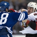 Toronto Maple Leafs left winger Fraser McLaren (38) knocks out Ottawa Senators left winger Dave Dziurzynski during a fight in first-period NHL hockey game action in Toronto, Wednesday, March 6, 2013. (AP Photo/The Canadian Press, Frank Gunn)
