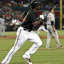 Arizona Diamondbacks' Justin Upton, left, and San Francisco Giants' Ryan Vogelsong (32) watch Upton's two-run double hit the wall in the third inning of a baseball game Sunday, Sept. 16, 2012, in Phoenix.(AP Photo/Ross D. Franklin)