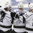 Los Angeles Kings' Drew Doughty, left, celebrates with teammates Dwight King, center, and Trevor Lewis, right, after scoring a goal against the New Jersey Devils during the first period of Game 2 of the NHL hockey Stanley Cup finals on Saturday, June 2, 2012, in Newark, N.J. (AP Photo/Kathy Willens)