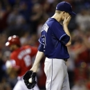 Tampa Bay Rays starting pitcher Jeremy Hellickson, right, reacts as Texas Rangers' Mitch Moreland rounds the bases after hitting a solo home run during the fourth inning of a baseball game, Monday, April 8, 2013, in Arlington, Texas. (AP Photo/LM Otero)