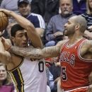 Chicago Bulls' Carlos Boozer (5) vies with Utah Jazz's Enes Kanter (0) for a rebound in the second quarter during an NBA basketball game Friday, Feb. 8, 2013, in Salt Lake City. (AP Photo/Rick Bowmer)