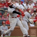 Cincinnati Reds' Brandon Phillips hits an RBI double during the ninth inning of a baseball game against the St. Louis Cardinals, Monday, April 8, 2013, in St. Louis. The Reds won 13-4. (AP Photo/Jeff Roberson)