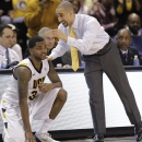 Virginia Commonwealth coach Shaka Smart talks to guard Troy Daniels during the first half of an NCAA college basketball game against Richmond in Richmond, Va., Wednesday, March 6, 2013. (AP Photo/Steve Helber)