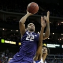Kansas State guard Rodney McGruder (22) gets past Kansas forward Kevin Young (40) to put up a shot during the first half of the championship NCAA college basketball game of the Big 12 men's tournament Saturday, March 16, 2013, in Kansas City, Mo. (AP Photo/Charlie Riedel)