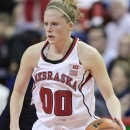 In this photo taken on March 3, 2013, Nebraska's Lindsey Moore handles the ball during an NCAA college basketball game against Penn State in Lincoln, Neb. Moore will set a Nebraska record when she makes her 128th consecutive start Friday, March 8, 2013 at the Big Ten tournament. Few, if any, players have meant as much to the Cornhuskers' program over a four-year career. (AP Photo/Nati Harnik)