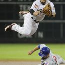 Houston Astros' Jose Altuve, top, goes high to avoid Chicago Cubs' David DeJesus who is out at second base in the first inning of a baseball game, Tuesday, May 22, 2012, in Houston. Cubs' Reed Johnson was safe at first on the fielder's choice. (AP Photo/Pat Sullivan)