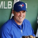 FILE - In this Sept. 7, 2012, file photo, Toronto Blue Jays manager John Farrell sits in the dugout before the Blue Jays' baseball game against the Boston Red Sox in Boston. The Red Sox reportedly have reached an agreement to bring Farrell to Boston to replace Bobby Valentine. Red Sox spokeswoman Pam Kenn said early Sunday, Oct. 21, 2012, the team had no announcement to make. Comcast SportsNet New England reported that the deal was agreed to. (AP Photo/Michael Dwyer, File)